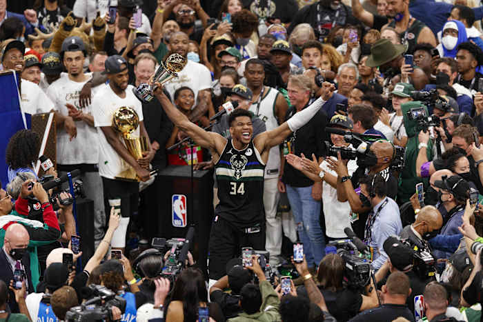 Milwaukee Bucks forward Giannis Antetokounmpo (34) celebrates with the NBA Finals MVP Trophy